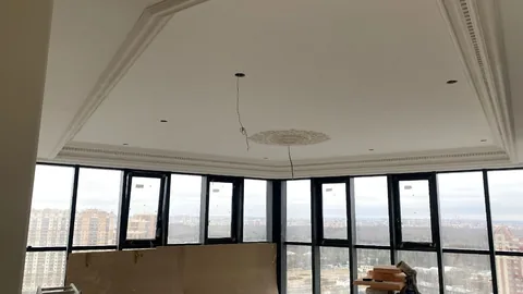 Комната с панорамными окнами на этапе отделки до установки мебели